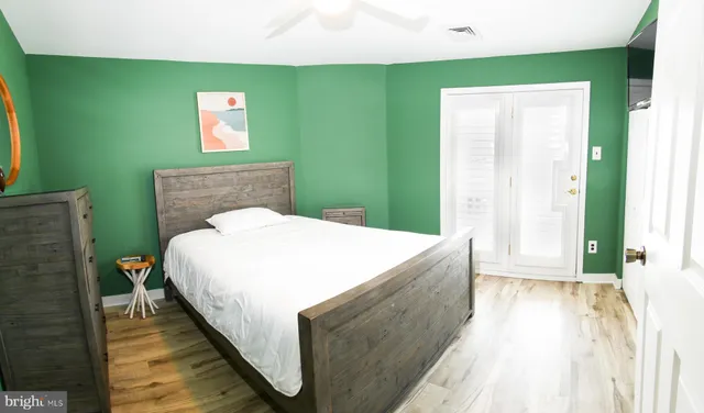 a spacious bedroom with a bed and a window