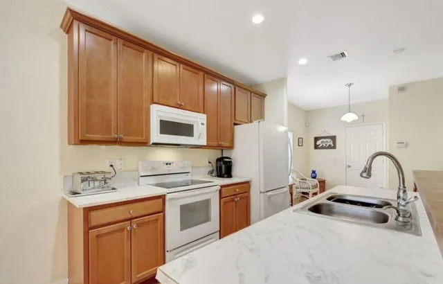 a kitchen with stainless steel appliances a sink stove and refrigerator