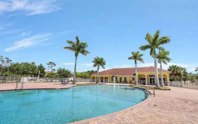 a view of swimming pool with outdoor seating and deck
