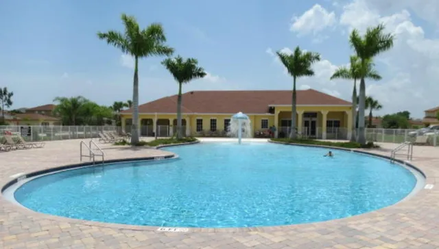 a swimming pool with outdoor seating and yard