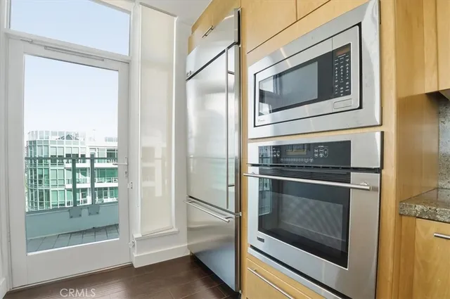 a kitchen with granite countertop cabinets stainless steel appliances and a counter top