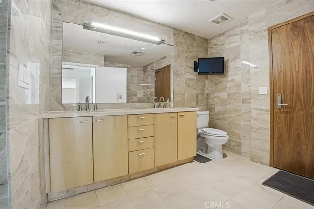 a bathroom with a toilet sink and mirror