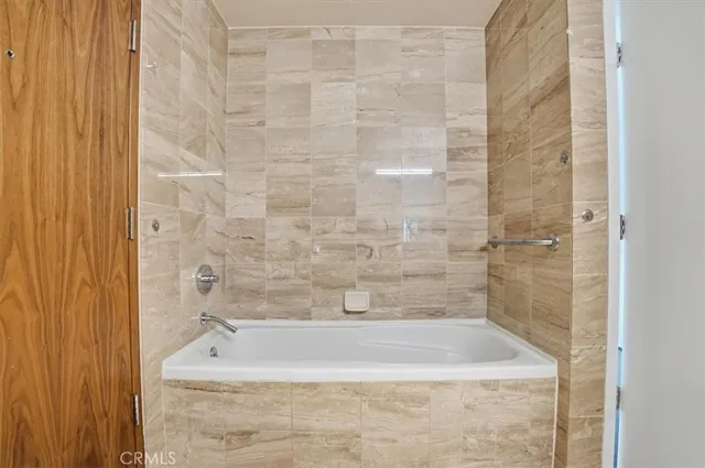 a bath tub sitting next to a white sink