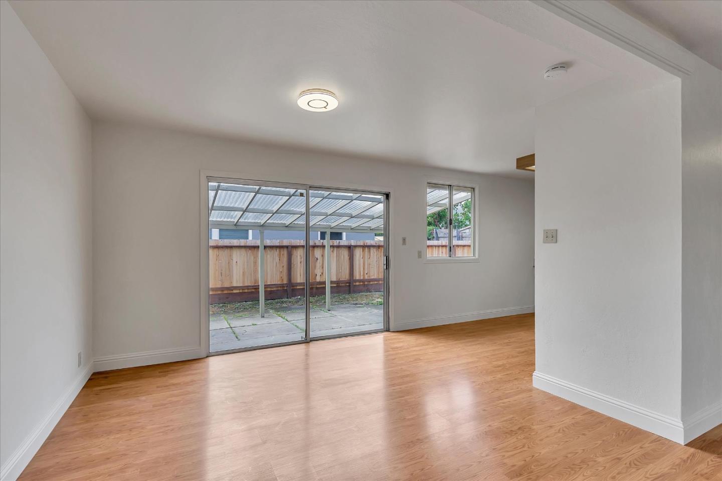 728 Arguello Boulevard Pacifica, CA 94044 - Photo 11 of 34 wooden floor in an empty room with a window