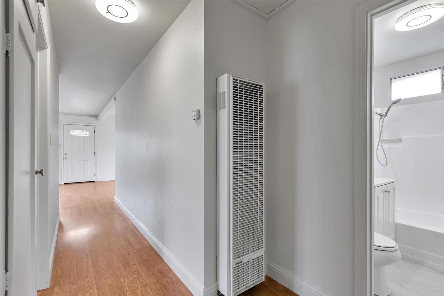 728 Arguello Boulevard Pacifica, CA 94044 - Photo 27 of 34 a view of a hallway with wooden floor and a bathroom