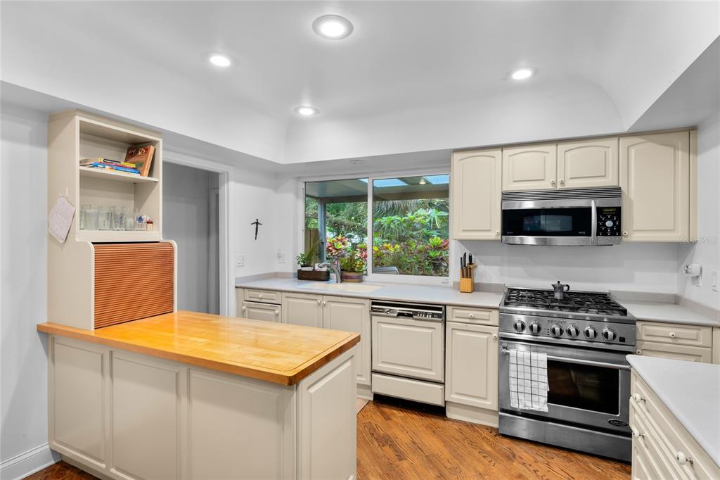 120 Beach Street Ponce Inlet, FL 32127 - Photo 17 of 91 a kitchen with stainless steel appliances a stove sink microwave and cabinets