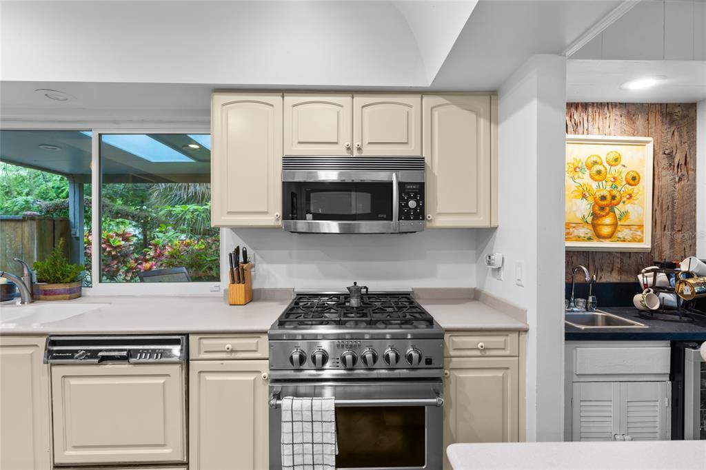 120 Beach Street Ponce Inlet, FL 32127 - Photo 18 of 91 a kitchen with granite countertop a stove a sink and a microwave