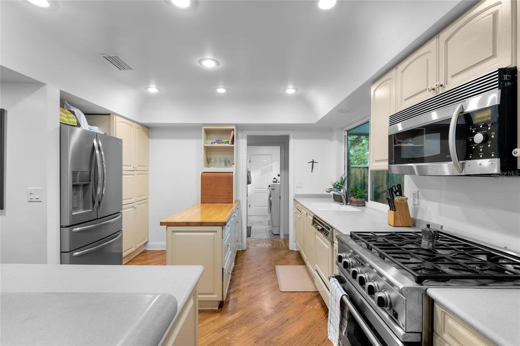 120 Beach Street Ponce Inlet, FL 32127 - Photo 22 of 91 a kitchen with stainless steel appliances a stove a sink a refrigerator cabinets and a dining table
