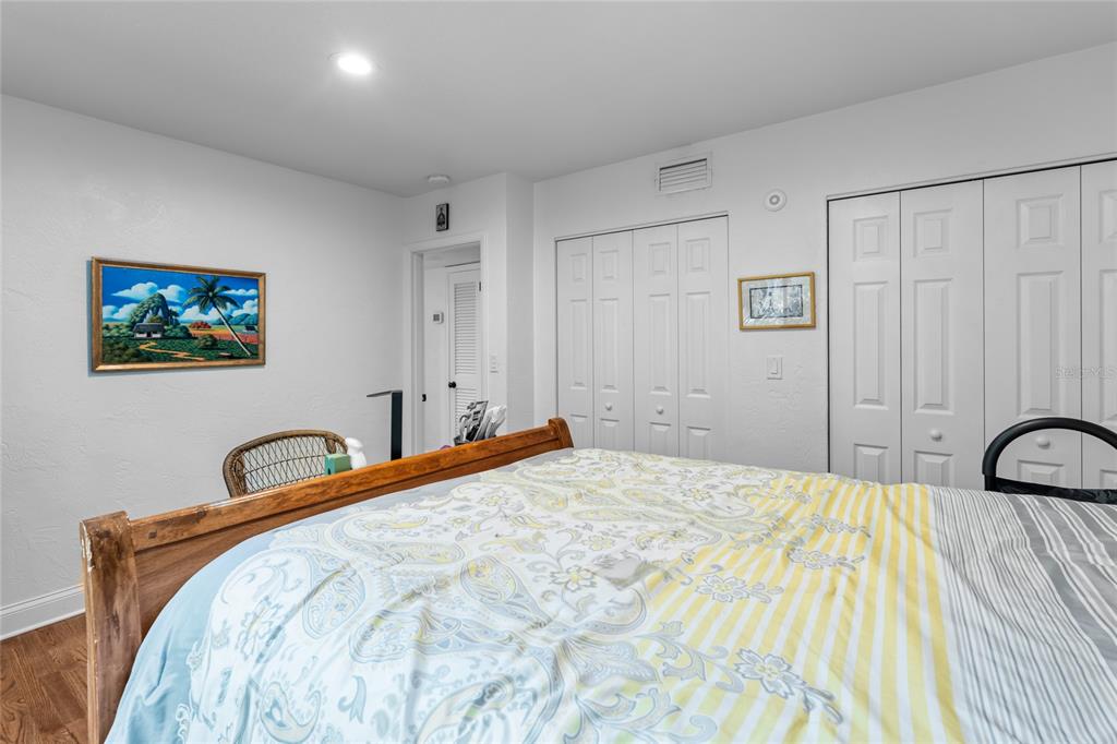 120 Beach Street Ponce Inlet, FL 32127 - Photo 32 of 91 a bedroom with a bed and a painting on the wall
