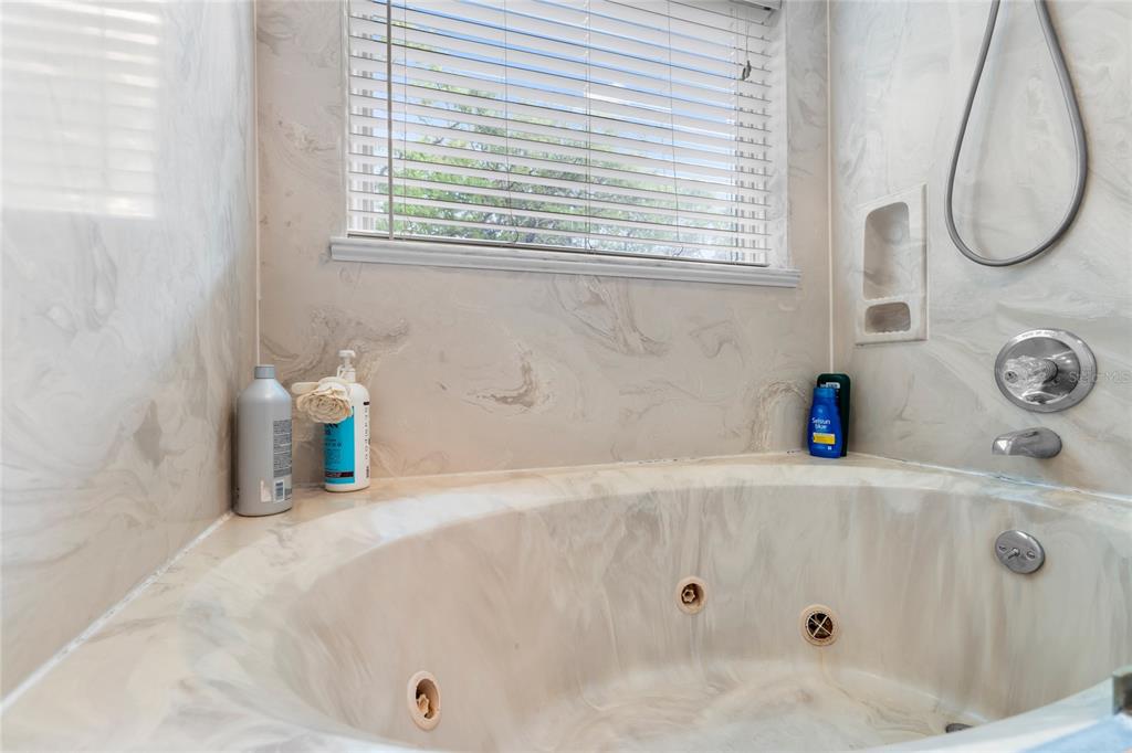 120 Beach Street Ponce Inlet, FL 32127 - Photo 39 of 91 a bathroom with a tub a sink and a window