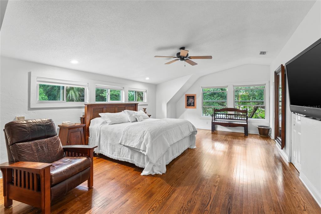 120 Beach Street Ponce Inlet, FL 32127 - Photo 40 of 91 a spacious bedroom with a bed and a couch