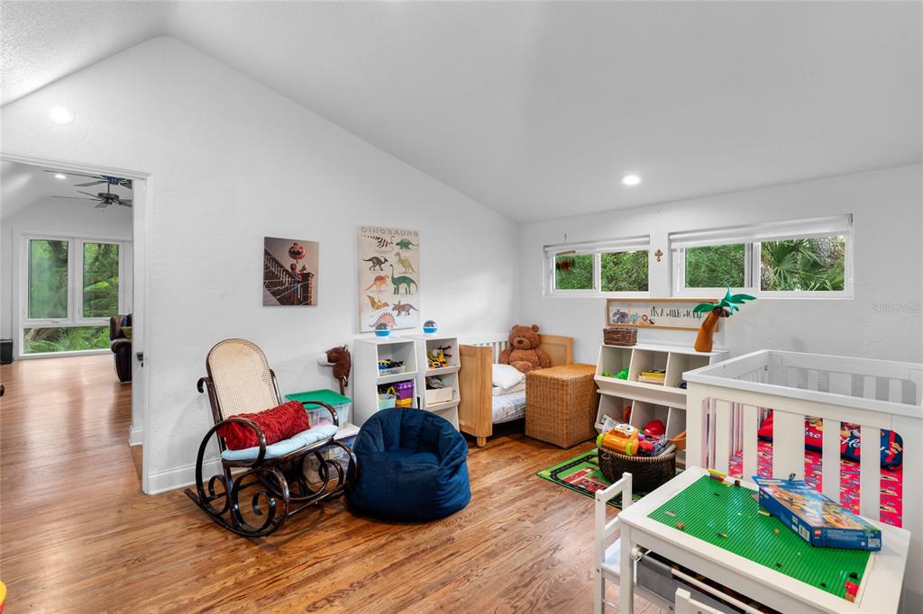 120 Beach Street Ponce Inlet, FL 32127 - Photo 48 of 91 a living room with furniture and a book shelf