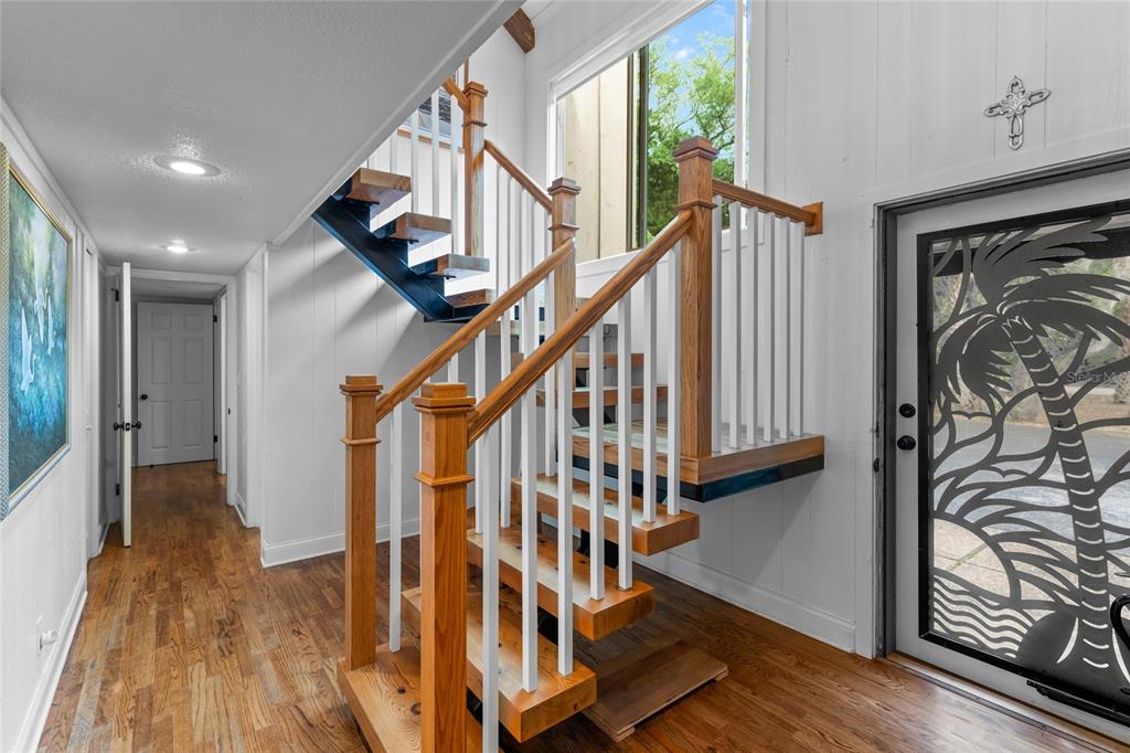 120 Beach Street Ponce Inlet, FL 32127 - Photo 6 of 91 a view of entryway with wooden floor and stairs