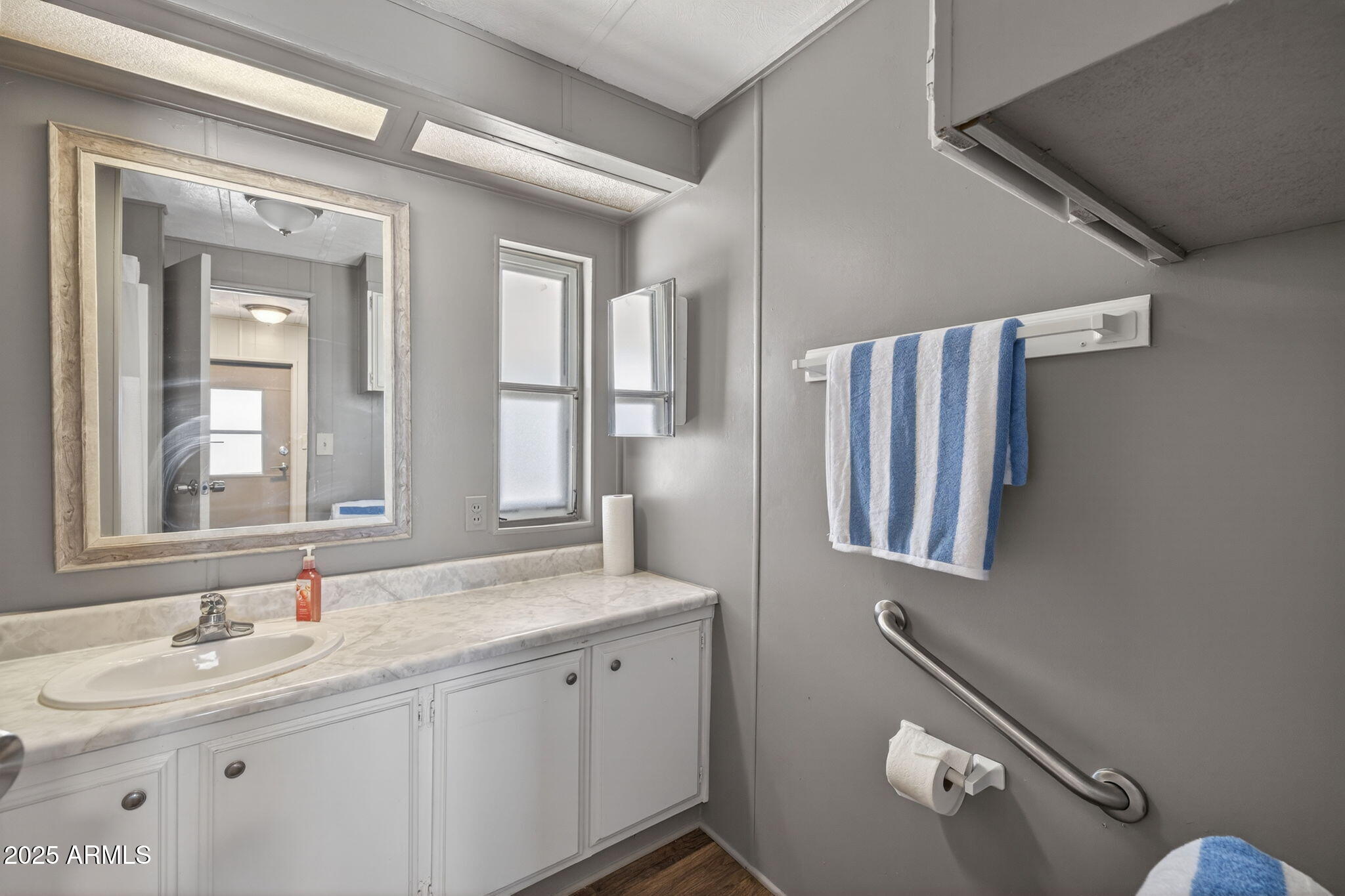 201 South Greenfield Road, Unit 310 Mesa, AZ 85206 - Photo 18 of 34 a bathroom with a double vanity sink and mirror