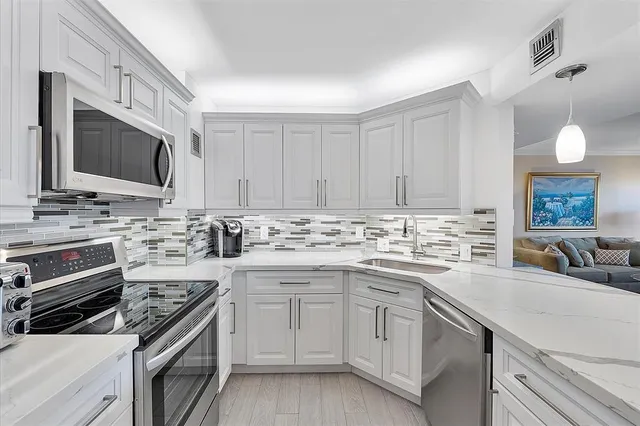 a dining room with furniture a chandelier and wooden floor