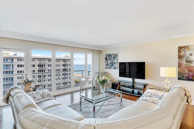 a kitchen with stainless steel appliances granite countertop a refrigerator a sink a stove and white cabinets