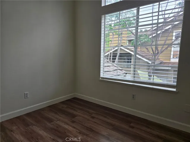 a view of a small space with wooden floor and a window
