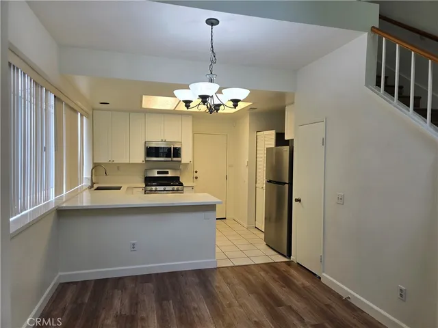 a view of a kitchen with a sink wooden floor and a kitchen