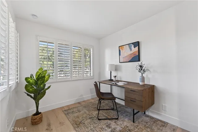 a view of a workspace with furniture and a potted plant