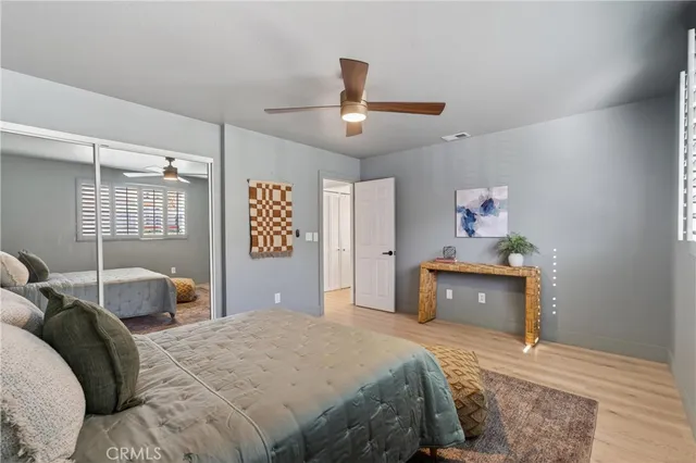 a bedroom with a bed and wooden floor