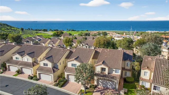 an aerial view of a house with a ocean view