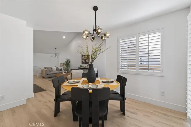 a dining room with furniture a chandelier and window