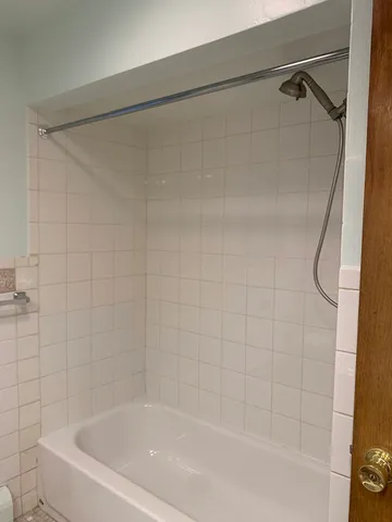 a bathroom with a shower and a bath tub