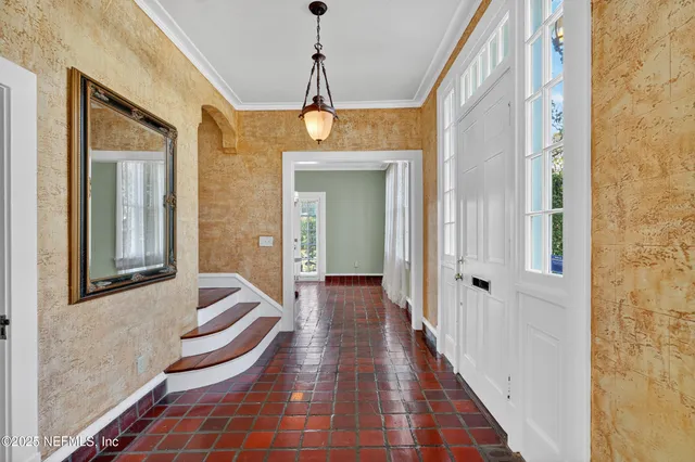 a living room with wooden floor and a fireplace