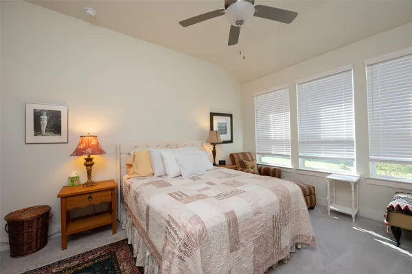 a bedroom with a bed and a large window