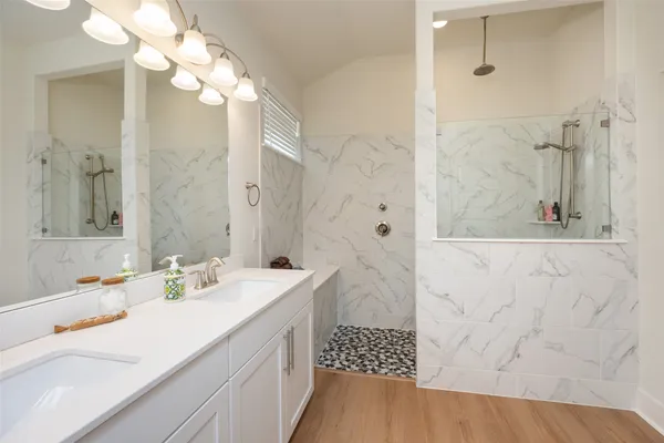 a bathroom with a sink a mirror and a shower