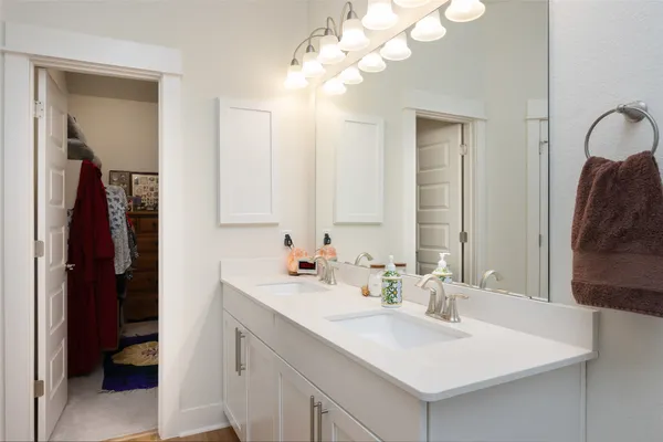 a bathroom with a sink vanity and a mirror