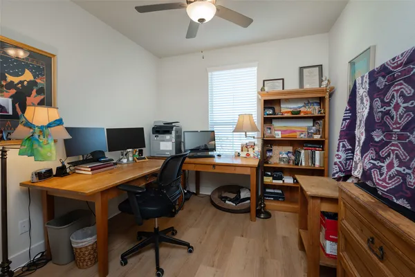 a view of a workspace with furniture and bookshelf