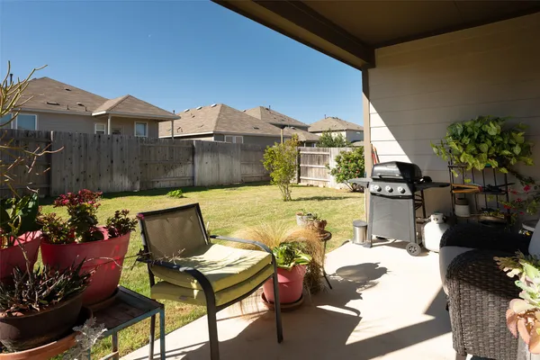 a view of a chairs and table in patio
