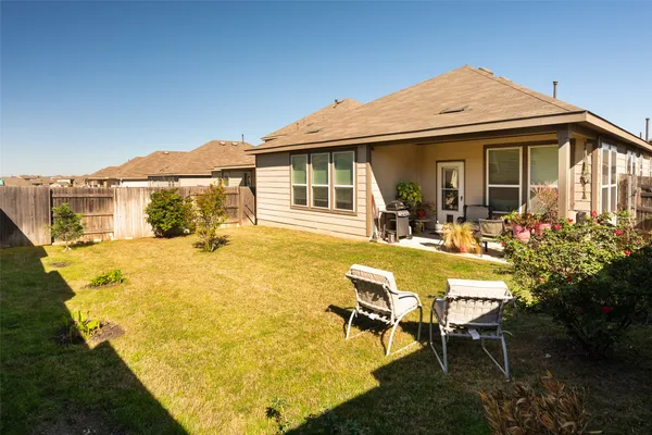 a view of a house with swimming pool and sitting area