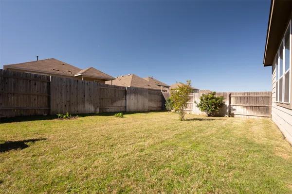 an aerial view of a house with outdoor seating