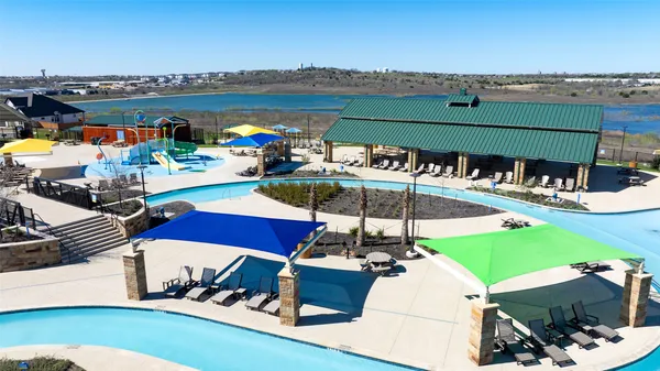 a view of a swimming pool with a table and chairs