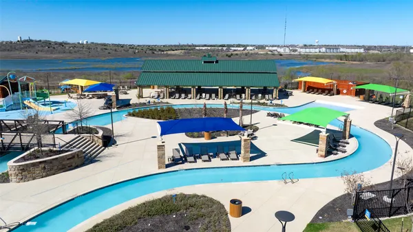 an aerial view of a house with a garden and lake view