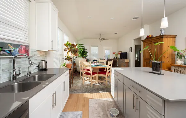 a kitchen that has a lot of cabinets a sink and a stove