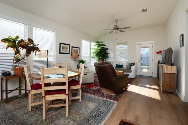 a living room with furniture a chandelier and a rug