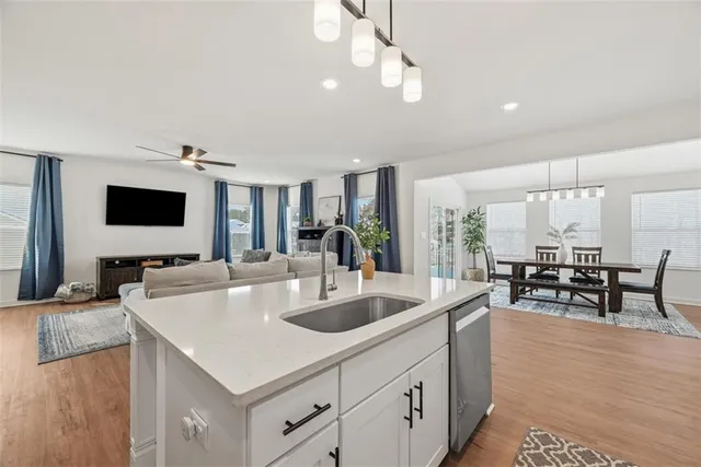 a large kitchen with kitchen island a large counter space and stainless steel appliances