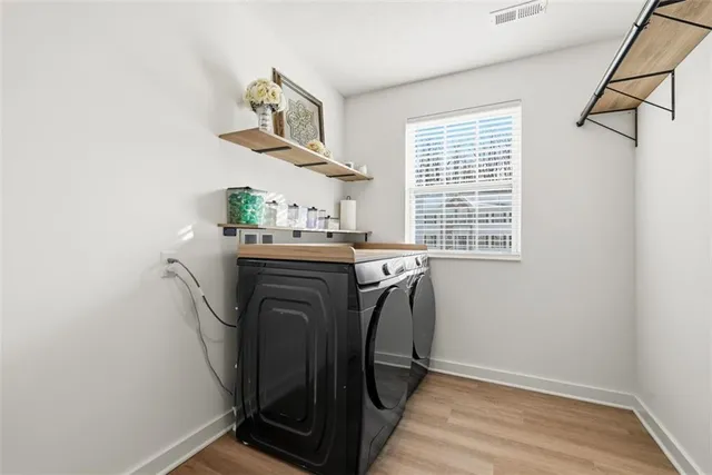 a dining room with a window and wooden floor
