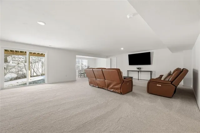 a living room with furniture flat screen tv and a window