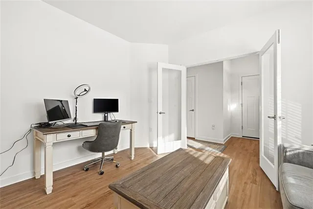 a view of a workspace with furniture and wooden floor