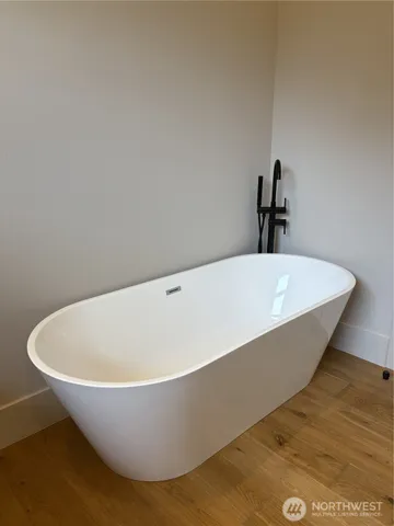 a white tub sitting in a bathroom