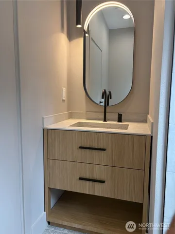 a bathroom with a sink and a mirror