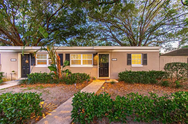 a front view of a house with a yard and outdoor seating