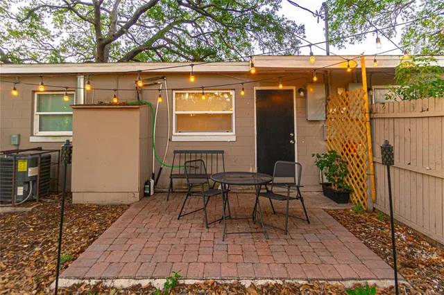 a view of a chairs and table in the back yard of the house