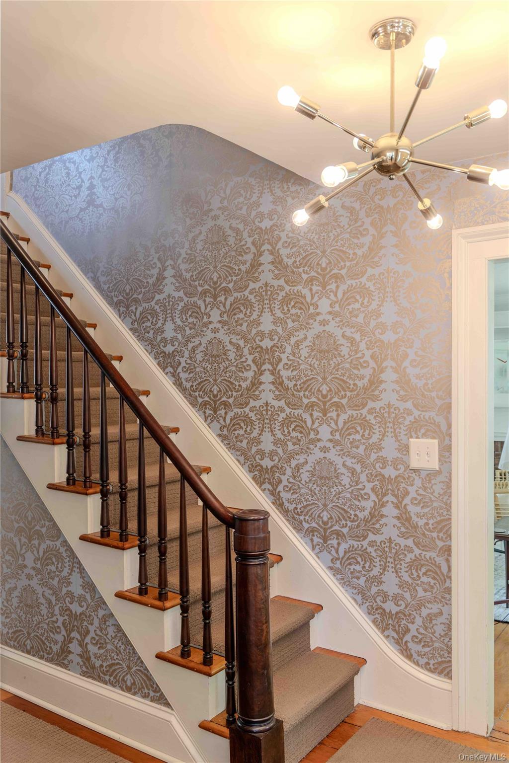 210 Middle Road Hudson, NY 12534 - Photo 12 of 42 Staircase featuring dark wood newel post and handrail, carpeted treads, and ornate patterned wallpaper