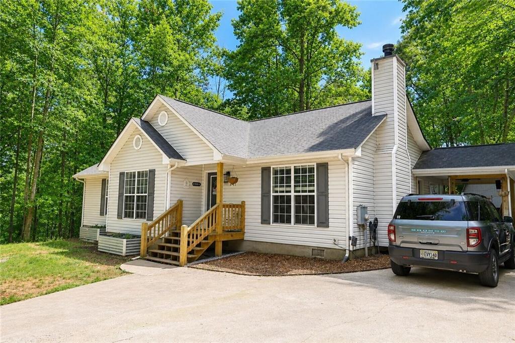 2033 Carson Segars Road Maysville, GA 30558 - Photo 2 of 41 a view of a house with a yard and balcony