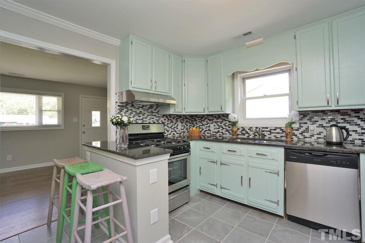 700 Darby Street Raleigh, NC 27610 - Photo 1 of 23 a kitchen with granite countertop white cabinets and white appliances